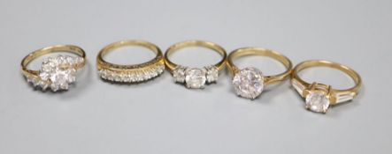 Five assorted modern 14ct gold and CZ set dress rings, gross 13 grams.