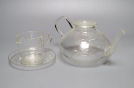 A Jenaer Glas teapot and cover cream jug and under dish, by Schott & Genossen, Mainz, designed by