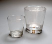 A trick double walled glass tumbler and a dram glass tumbler, 19th and late 18th century, the former