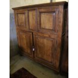 A 19th century French panelled walnut press cupboard fitted upper and lower pairs of doors, width