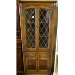 A modern oak leaded glazed standing corner cabinet, width 68cm depth 36cm height 167cm