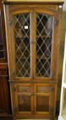 A modern oak leaded glazed standing corner cabinet, width 68cm depth 36cm height 167cm