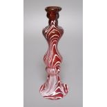 A Victorian hollow ruby glass candlestick with combed white trailed decoration, 23cm high