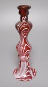 A Victorian hollow ruby glass candlestick with combed white trailed decoration, 23cm high