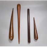 Three 19th century lignum vitae fids and a similar rule, longest 45.5cm