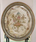 An early 19th century silkwork panel of flowers in a cornucopia, oval 50 x 42cmCONDITION: Embroidery