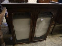 An early 18th century walnut bookcase top, width 100cm height 99cmCONDITION: Right hand glass has