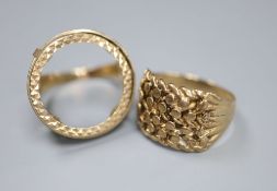 A 9ct gold gentleman's pierced and textured ring and a similar sovereign ring (with vacant mount),