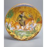 A 19th century Montelupo-style maiolica pottery charger, polychrome-decorated with an equestrian