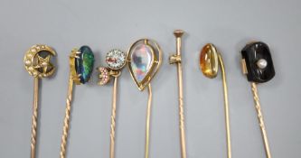 Seven assorted Edwardian gem set stick pins including 18ct and seed pearl, gross 2 grams, 14k and