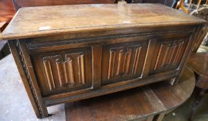 A reproduction oak linenfold coffer, width 104cm depth 45cm height 51cm