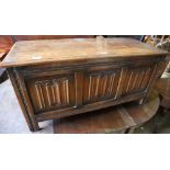 A reproduction oak linenfold coffer, width 104cm depth 45cm height 51cm