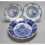 A late 18th century Dutch Delft blue and white deep plate (de Blompot marks) and two smaller Delft