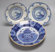 A late 18th century Dutch Delft blue and white deep plate (de Blompot marks) and two smaller Delft