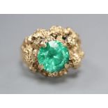 An early 1970's 9ct gold and green paste? set rustic dress ring, size L/M, gross 6 grams.