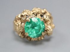 An early 1970's 9ct gold and green paste? set rustic dress ring, size L/M, gross 6 grams.