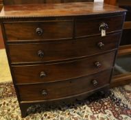 A bow-fronted mahogany chest fitted two two short drawers and three long drawers with beaded