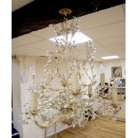 A French cream painted eight branch chandelier with painted cream leaves and crystal flowers, height