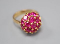 A mid to late 20th century Italian? 750 and synthetic? ruby cluster dress ring, size M/N, gross 8.