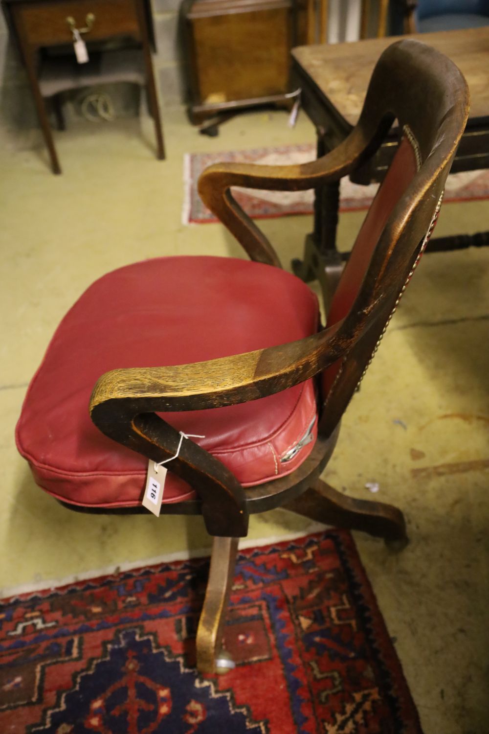 A 1920's oak swivel desk chair, the back and seat cushion covered in red hide, width 63cm, depth - Image 2 of 3