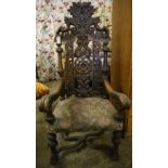 A late 19th century Flemish carved oak elbow chair, width 88cm height 150cm