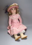 A French bisque head jointed doll, with pierced ears and paperweight cane eyes, with closed mount