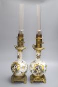 A pair of Rouen style faience and gilt metal mounted oil lamps, total height 64cm