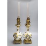 A pair of Rouen style faience and gilt metal mounted oil lamps, total height 64cm