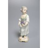 A Continental porcelain figure of a girl holding a fish, late 18th century, possibly Bueno Retiro (