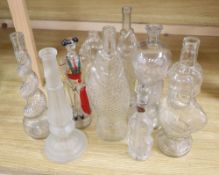 Nine moulded glass bottles, including one coloured and formed as a matador tallest 33cmCONDITION: