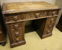 A 19th century Flemish carved oak kneehole desk, width 106cm depth 60cm height 75cm