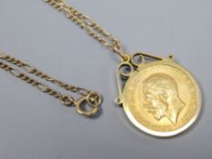 A 1914 half sovereign in 9ct gold mount on 9ct gold chain, gross 8.4g.