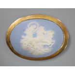 A late Victorian yellow metal mounted oval Wedgwood plaque brooch, depicting a maiden with chariot