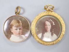 A late Victorian 9ct double sided glazed locket, 33mm and other yellow metal mounted glazed pendant,