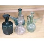 Four 19th/20th century French coloured glass porron decanters and a vine engraved carafe, 20.5 -