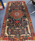 A Persian red ground rug, 282 x 134cm