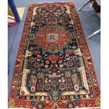 A Persian red ground rug, 282 x 134cm