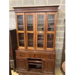 A Victorian mahogany bookcase cupboard, with pull out mid section writing slide, width 144cm depth