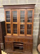 A Victorian mahogany bookcase cupboard, with pull out mid section writing slide, width 144cm depth