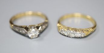 A solitaire diamond ring on yellow metal shank with diamond-set shoulders , size L/M, gross 3.2