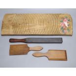 A 19th century Continental beech board, 53cm, a pair of beech butter pats and a mahogany paddle