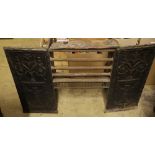 A Victorian cast iron grate, with decorative side panels, in two parts, width 97cm height 85cm
