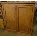 A late Victorian pine two door cupboard, width 123cm depth 52cm height 125cm