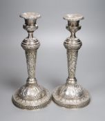 A pair of late George III silver candlesticks, with later embossed decoration, Soloman Hougham,