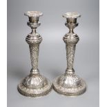 A pair of late George III silver candlesticks, with later embossed decoration, Soloman Hougham,