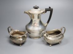 A matched late 19th/early 20th century demi-fluted silver three piece tea set, Sheffield, 1899 &