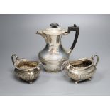 A matched late 19th/early 20th century demi-fluted silver three piece tea set, Sheffield, 1899 &