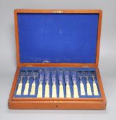 A Victorian set of twelve plated and engraved fish knives and forks, with carved ivory handles,