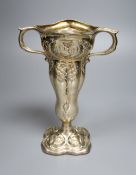 An Edwardian Art Nouveau repousse silver two handled vase, decorated with mother & child,