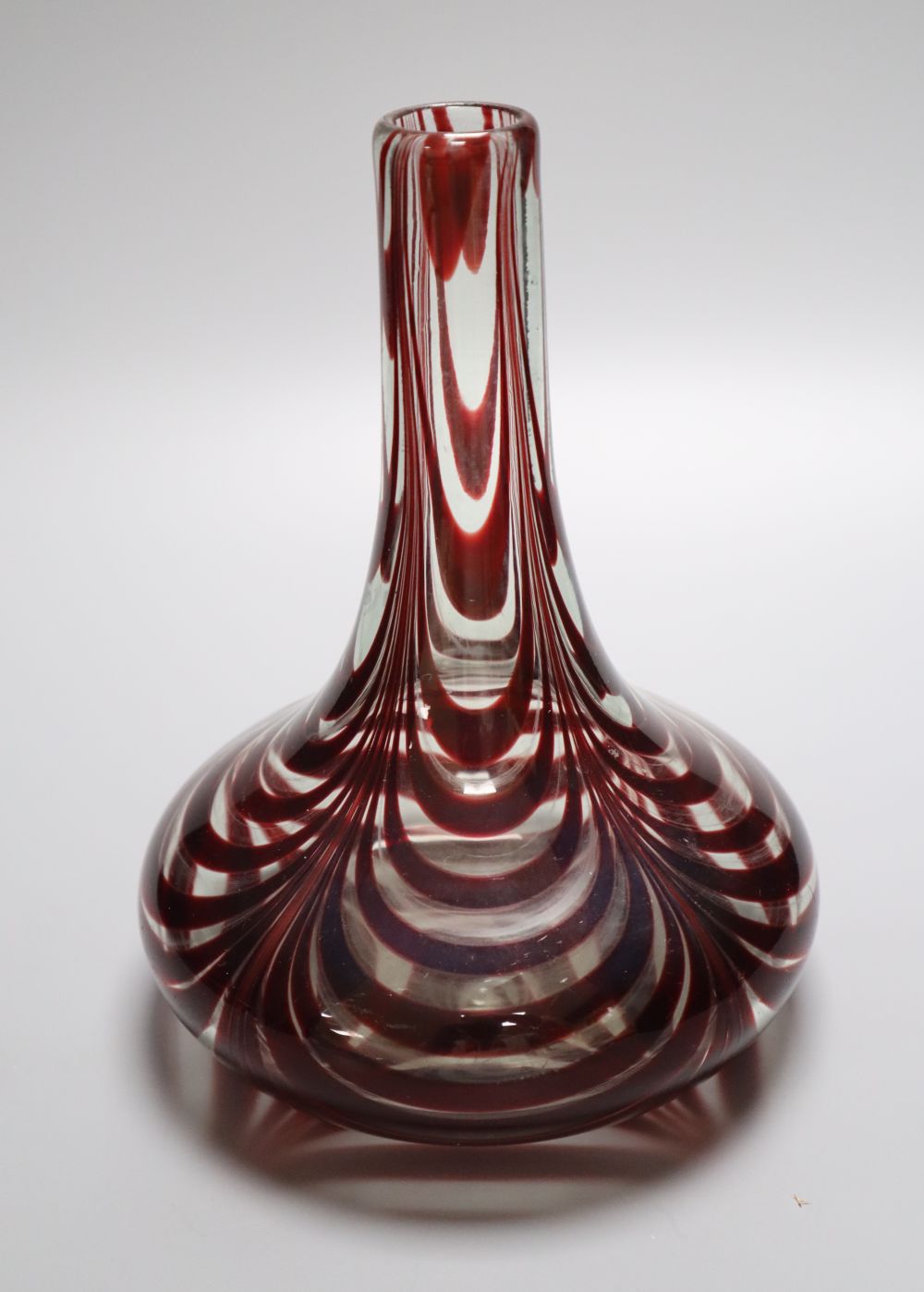 A Victorian red trail glass carafe with bold concentric looped decoration, 20cm highCONDITION: